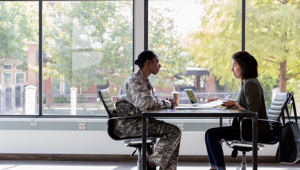 Female soldier meets with a business professional.